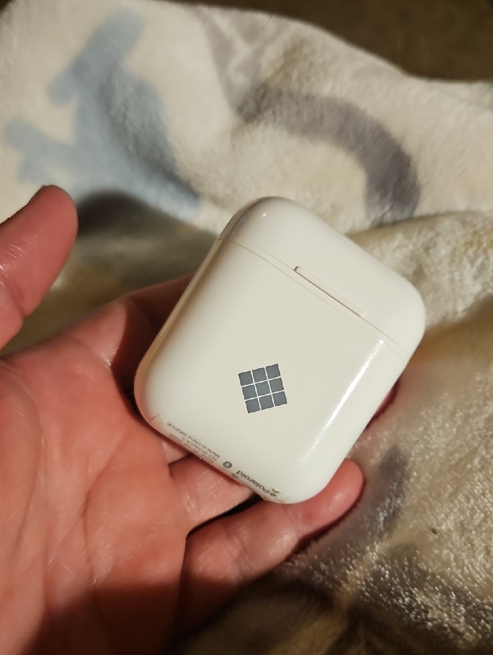 Polaroid White Earbud Charging Case with Gray Grid Logo